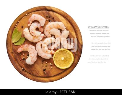 Frozen shrimps on a wooden board, white background, copy space Stock Photo