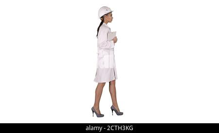 Attractive Hispanic woman in white lab coat and white safety har Stock Photo