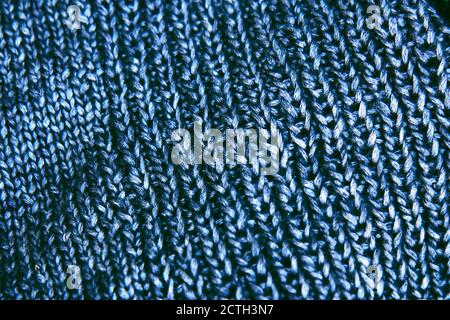 Texture beautiful knitted bright blue fabric with metallic fibers as background. Copy space. Female hobby concept. Needlework Stock Photo