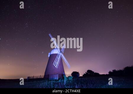 Halnaker windmill silhouetted against the night sky full of stars, painted with light from a torch  Sussex, UK, Stock Photo