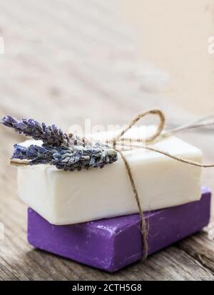 Lavender soap bars and fresh flowers closeup view. Natural herbal cosmetics, healthy beauty products. Stock Photo