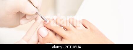 Classic pink wedding toe nail manicure on white backdrop. Spa treatment concept Stock Photo
