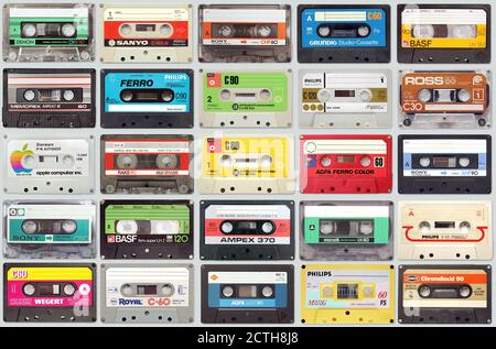 Large set of old vintage audio tape cassettes on gray background, colorful retro music background Stock Photo