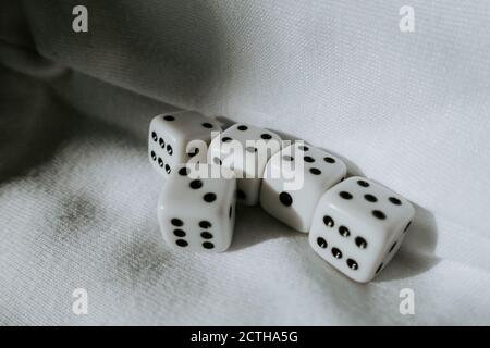 Five dice showing different numbers on white background Stock Photo