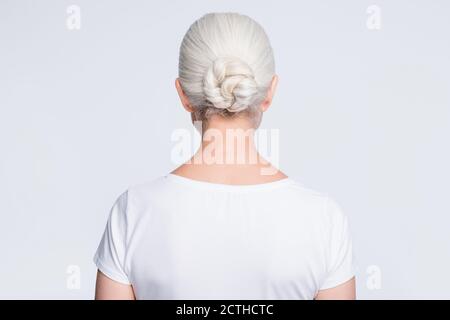 Back rear photo of old lady standing backside wearing t-shirt isolated over white background Stock Photo