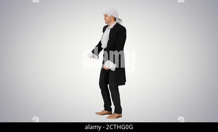 A man dressed as a courtier doing nothing and waving hands on gr Stock Photo