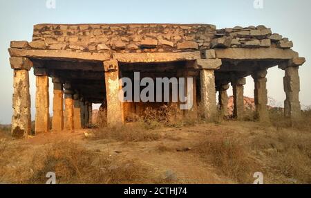 Ruins of an ancient temple at sunset located at Hemakuta hill in Hampi, Karnataka, India Stock Photo