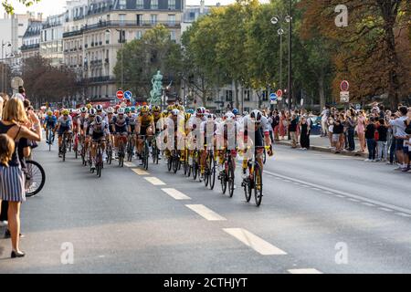 Paris, France - 2020 September 20 - Tour de France peloton approaches finish line surrounded by spectators Stock Photo