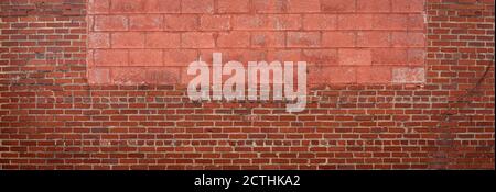 Panorama of red brick with red painted concrete block insert, vignette urban background pattern, creative copy space, horizontal aspect Stock Photo