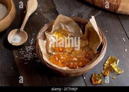 Salted caramel candy shards in a wicker basket Stock Photo