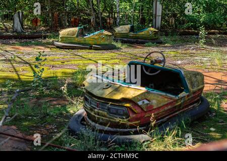 Abandoned Amusement Car Ride in park of attractions in Ghost City of Pripyat in Chernobyl Exclusion Zone, nuclear catastrophe Stock Photo