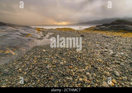 Rainy clouds and sun breaking through Stock Photo