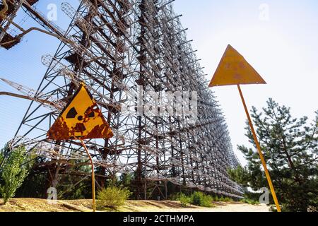 Former military Duga radar system and radioactive signs near ghost town Pripyat in Chernobyl Exclusion Zone, Ukraine Stock Photo
