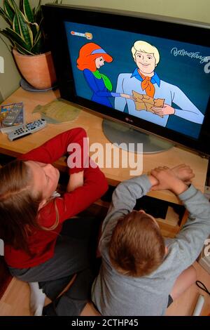 siblings watching scooby doo Stock Photo