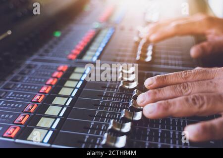 sound engineer hands working on sound mixer in live concert Stock Photo