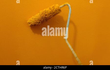 In motion paint roller against the wall Stock Photo