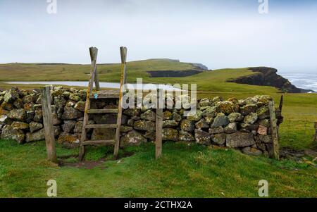 Footpath and wall on coast at Eshaness at Northmavine , north mainland of Shetland Islands, Scotland, UK Stock Photo