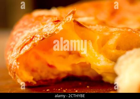 Close-up. Melted cheese into the core of a cheese cake. Broken Turkish cheesecake. Pita with cheese in a restaurant. Georgian Khachapuri, kubdari, lob Stock Photo