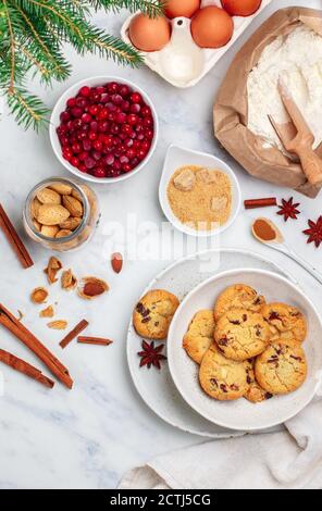 Freshly baked homemade Christmas cookies with cranberries, almonds, white chocolate, cinnamon and star anise. Delicious festive biscuit. Gingerbreads. Stock Photo