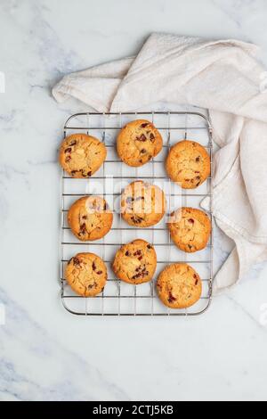 Freshly baked homemade Christmas cookies with cranberries, almonds and white chocolate on a marble background. Delicious festive biscuit. Gingerbreads Stock Photo