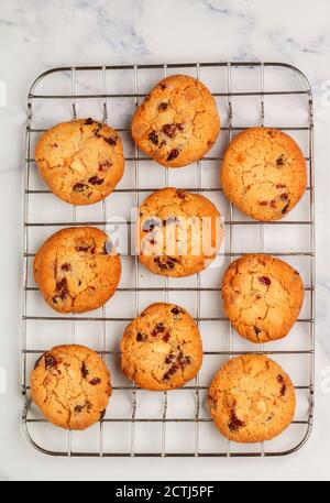 Freshly baked homemade Christmas cookies with cranberries, almonds and white chocolate on a marble background. Delicious festive biscuit. Gingerbreads Stock Photo