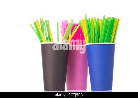 Colored plastic drinking straws in disposable cups isolated on white background Stock Photo