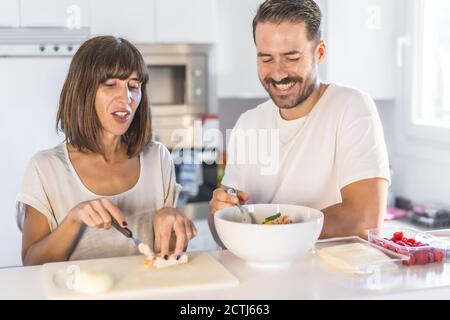 Caucasian couple cooking together at home and having a good time together Stock Photo
