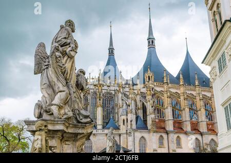 Saint Barbara's Cathedral Roman Catholic church Gothic style building and close-up baroque statues of saints in Kutna Hora historical Town Centre, Central Bohemian Region, Czech Republic Stock Photo