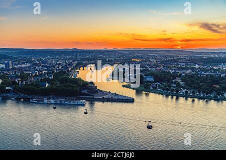 Aerial panoramic view of Koblenz historical city centre and joining Rhine and Moselle rivers, evening twilight view of amazing colorful orange sunset on horizon, Rhineland-Palatinate state Stock Photo