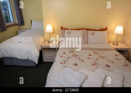 Typical basic two beds twin bedroom interior in self catering guest house and bed and breakfast apartment Stock Photo