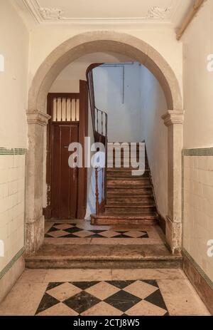 Decaying wooden staircase in an abandoned bulding Stock Photo