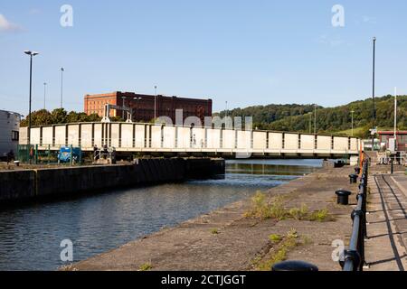 Merchants Road swing bridge and lock gates open for a boat to pass into the Floating Dock. junction lock bridge Bristol, England. Sept 2020 Stock Photo