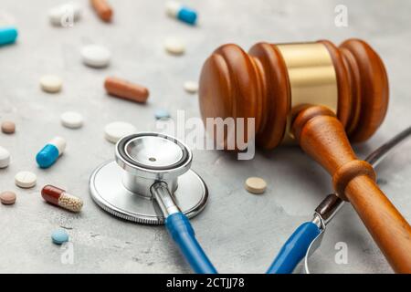 Judge gavel and stethoscope with pills. The law in medicine, the sentence on medical negligence Stock Photo