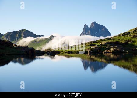 Ossau Peak reflected in Anayet lake in Tena Valley, Huesca province in Aragon, Pyrenees in Spain. Stock Photo