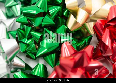 Colorful gift wrapping bows and silver sequins on white festive background.  Holiday copy space. Pull bow & ribbon, Top view Stock Photo - Alamy