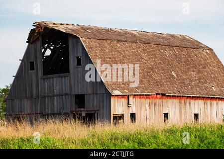 An old abandoned dilapidated wooden barn in the Oklahoma countryside in the late spring. USA. Stock Photo