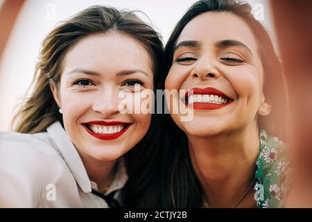 Close-up portrait of smiling beautiful female friends Stock Photo