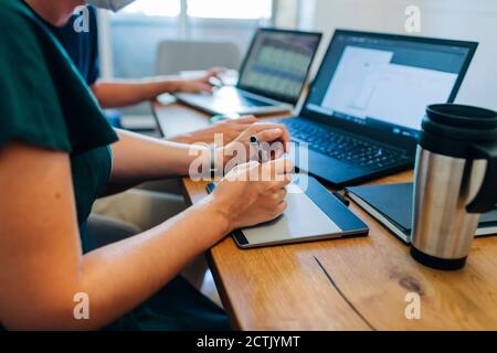 Female professional using graphics tablet at office Stock Photo