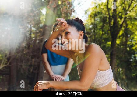 Exhausted woman taking a break on a fitness traii Stock Photo