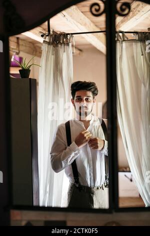 Groom getting ready for wedding at dressing room Stock Photo