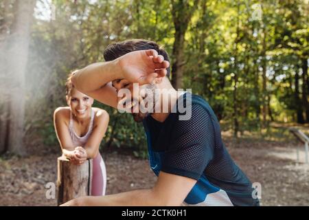 Exhausted man taking a break on a fitness traii Stock Photo