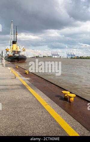 Germany, Hamburg, Cloudy sky over ship moored in Port of Hamburg Stock Photo