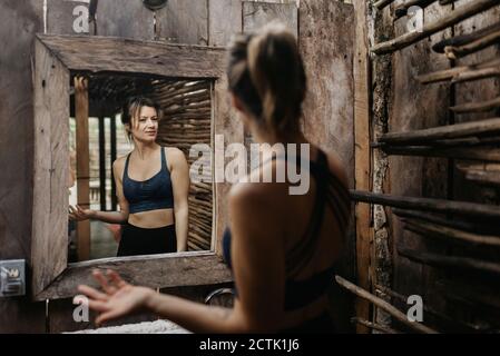 Smiling woman looking in mirror Stock Photo