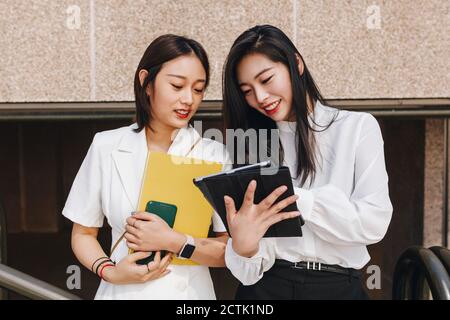 Colleagues working together on digital tablet Stock Photo