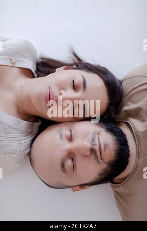 Man and woman lying on floor Stock Photo