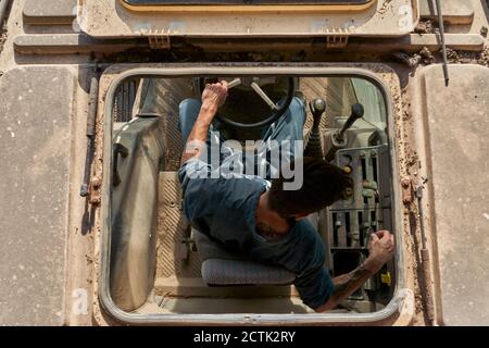 Directly above view of farmer driving tractor Stock Photo