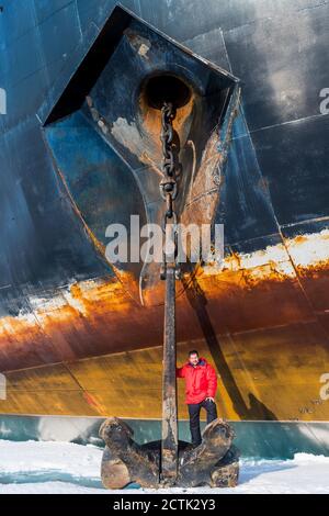 Portrait of man posing on top of anchor of ice-breaker 50 Years of Victory Stock Photo