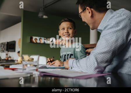 Father helping son with his homework Stock Photo