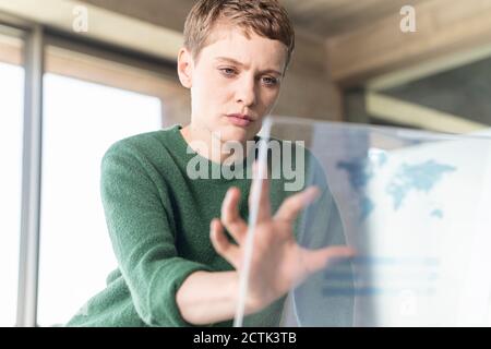 Businesswoman in office using virtual screen Stock Photo
