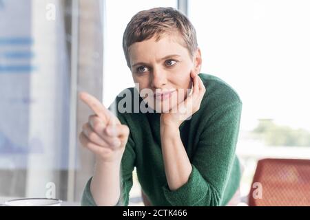 Businesswoman in office using virtual screen Stock Photo